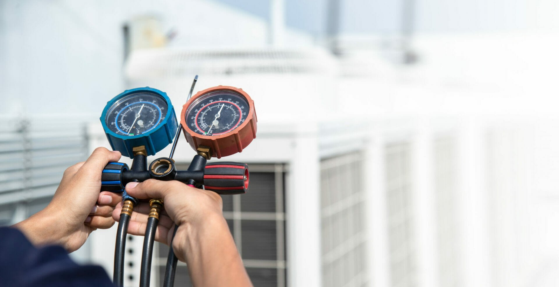A person holding a pressure gauge in Austin, TX.