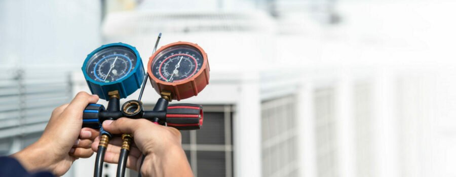 A person holding a pressure gauge in Austin, TX.